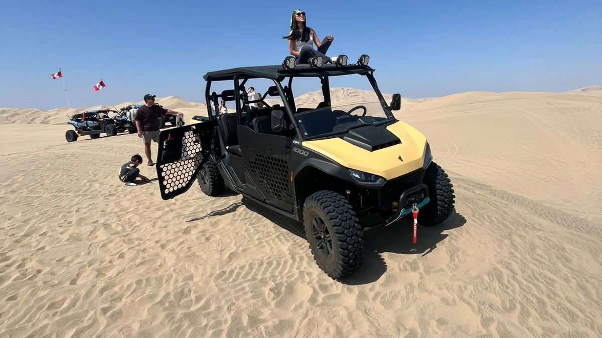 Four-seat UTV with roll cage on the dunes of Huacachina