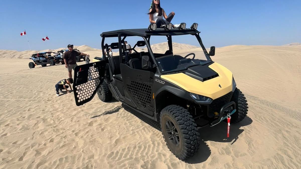 UTV moderno de cuatro plazas en las dunas de Huacachina, con más vehículos al fondo